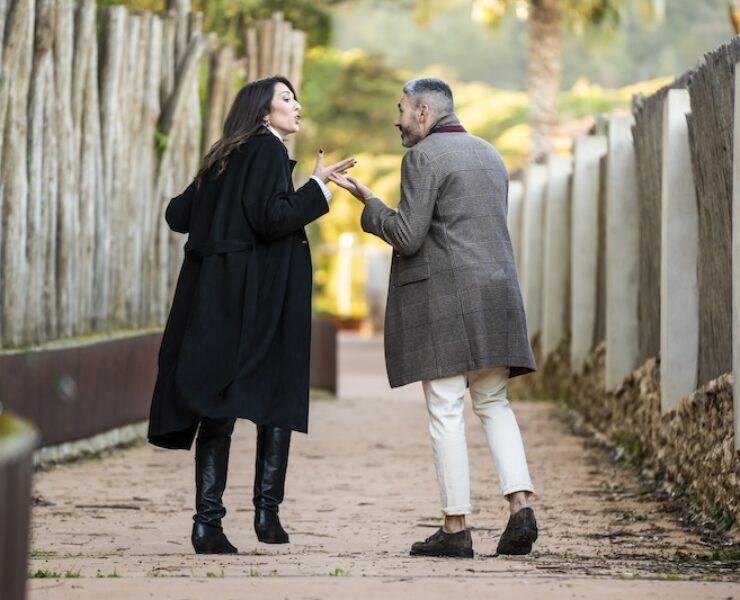 A couple walking on a path and arguing