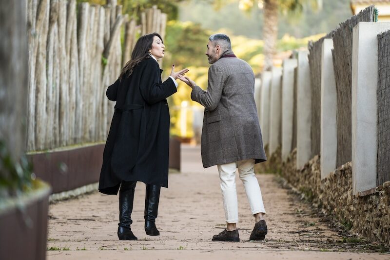 A couple walking on a path and arguing