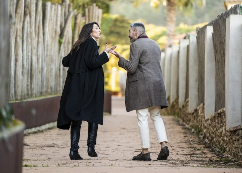 A couple walking on a path and arguing